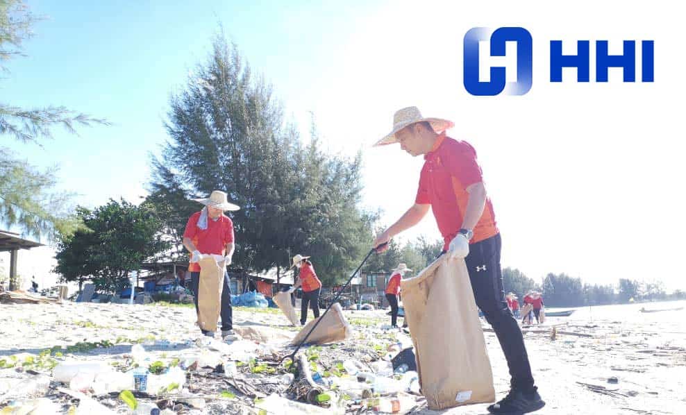 Person on beach picking up trash