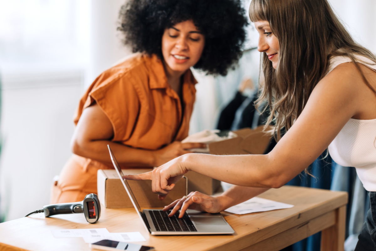 Women business owners looking at laptop