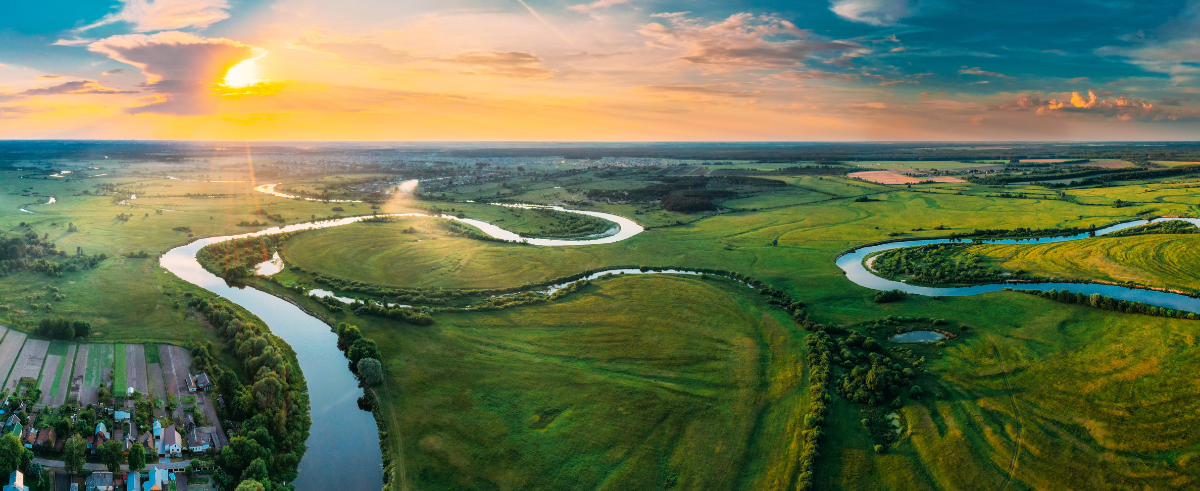 Aerial view of meadow and river landscape